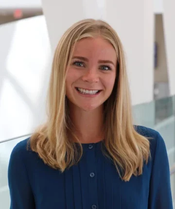 A photo of Dr. Hannah Coyle-Asbil in a blue blouse
